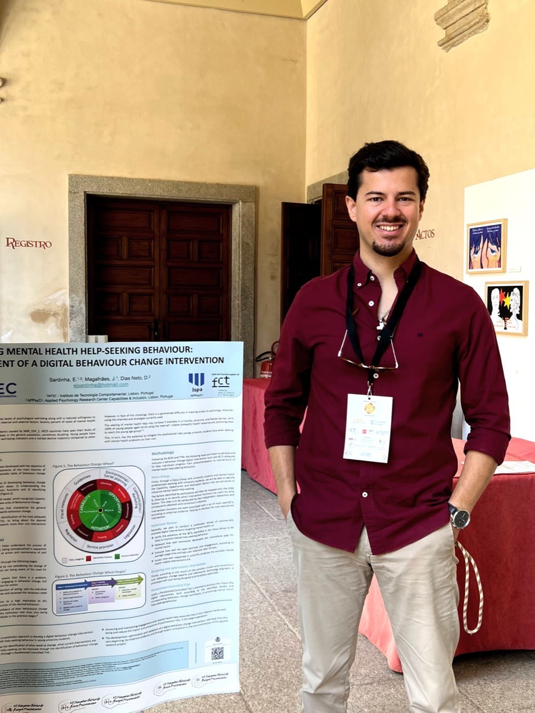Eduardo beside the poster at the VI SIRPS symposium